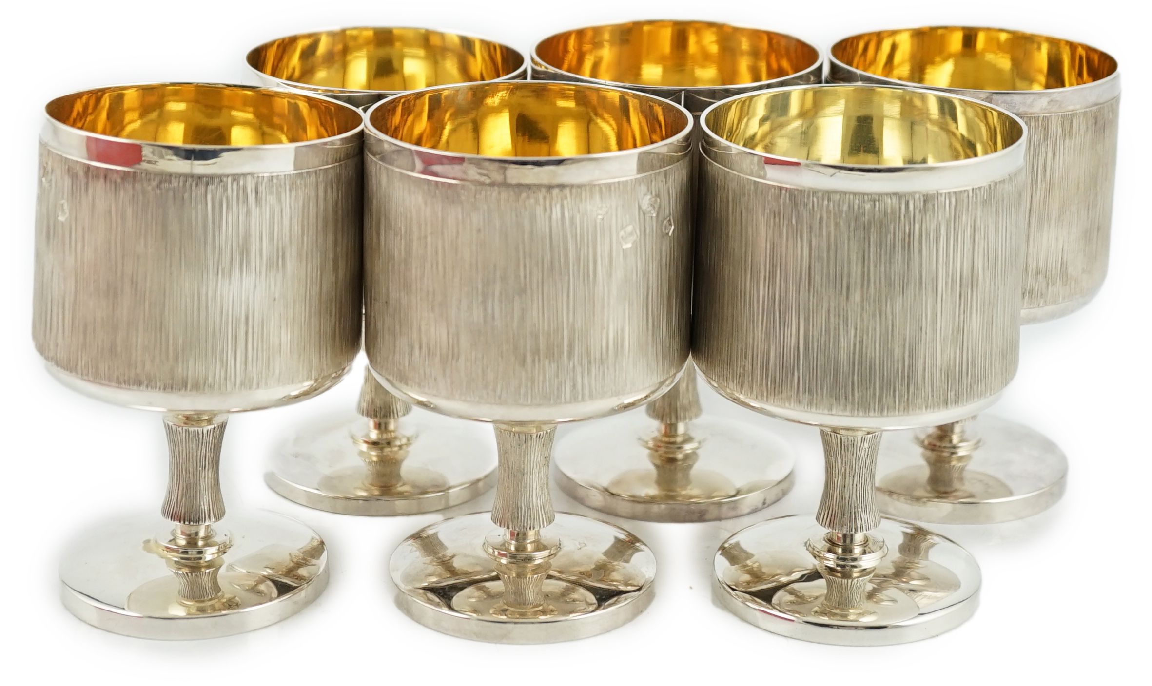 A set of six Elizabeth II textured silver pedestal goblets, by Garrard & Co Ltd